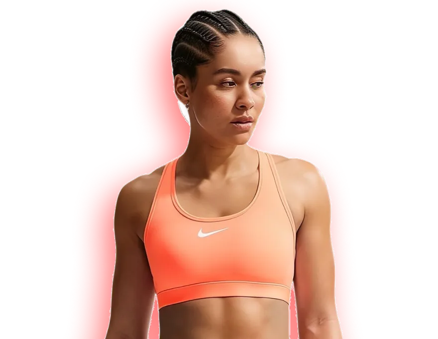 A runner wearing an orange Nike sports bra with medium support