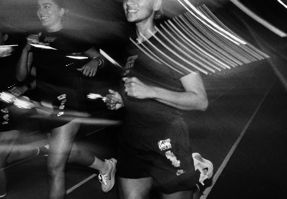 Runners mid-stride at night, streaked with motion blur