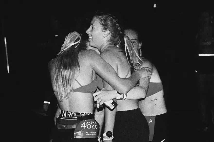 Runners embracing after a night race