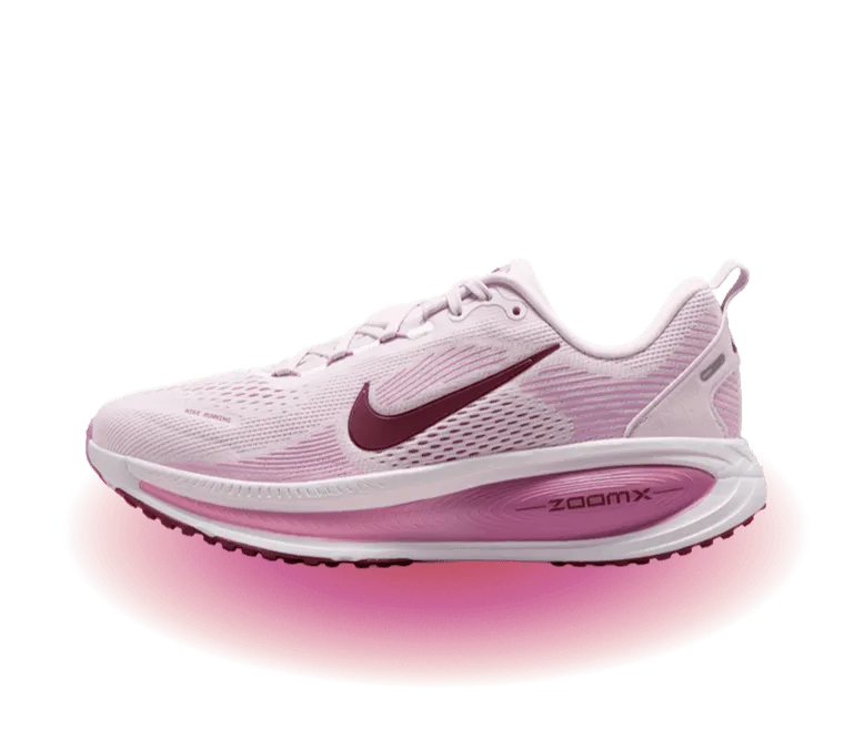 A white and pink Nike running shoe with maximum cushioning