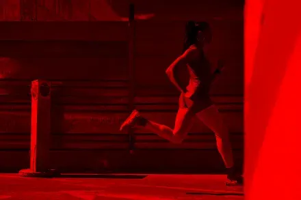 A runner on a red-lit street