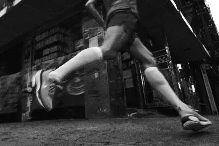 A runner mid-stride under an overpass