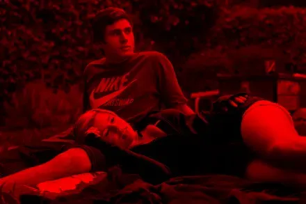 Two people resting on the grass