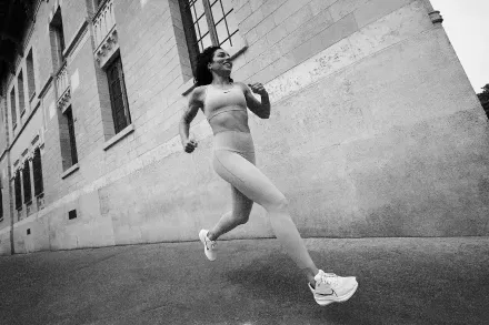 A runner beside a stone building